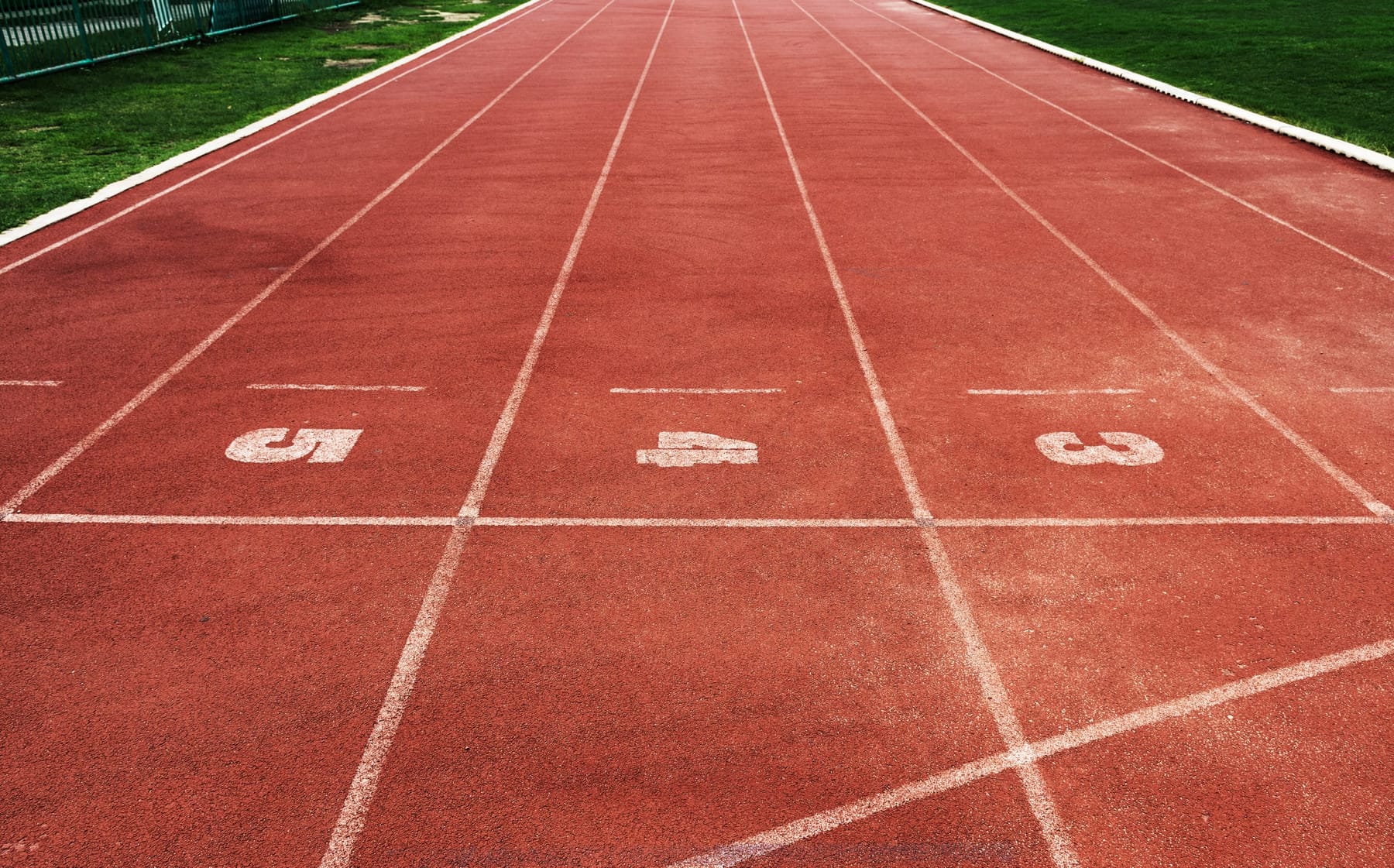 Athletics track lanes in strong light.