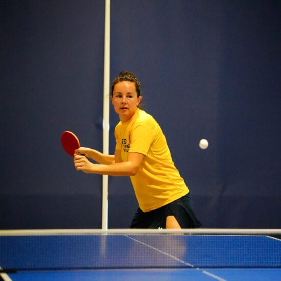 A table tennis coach at the table.
